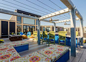 Thumbnail 38 of 47 - a patio with a table and chairs and a pergola at Ann Arbor City Club, Ann Arbor Michigan