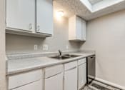 Thumbnail 18 of 50 - A kitchen with white cabinets and a granite countertop.