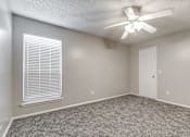 Thumbnail 16 of 50 - A room with a ceiling fan and a window with blinds.