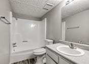 Thumbnail 15 of 50 - A white bathroom with a toilet, sink, and shower.