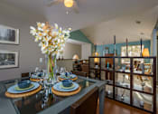 Thumbnail 8 of 26 - A dining room with a glass table set for two.