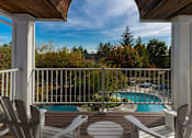 Thumbnail 20 of 26 - a view of a swimming pool from a porch with chairs at Village Club of Farmington Hills, Michigan, 48331