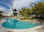 Thumbnail 18 of 26 - a swimming pool with a house in the background at Village Club of Farmington Hills, Farmington Hills Michigan
