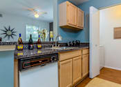 Thumbnail 10 of 26 - A kitchen with a white oven and wooden cabinets.
