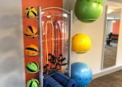 Thumbnail 13 of 18 - a gym with weights and balls on a rack