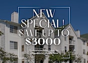 Thumbnail 12 of 12 - A large white building with a sign that says "NEW SPECIAL! SAVE UP TO $3000".