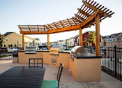 Thumbnail 13 of 37 - A wooden pergola is over a picnic table.