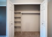 Thumbnail 8 of 17 - Large closet with shelving and bifold doors
