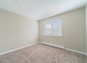 Thumbnail 10 of 17 - Bedroom with window, carpet, and baseboard heater