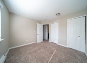 Thumbnail 11 of 17 - Bedroom with carpet and closet doors