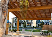 Thumbnail 14 of 37 - A wooden pergola over a hot tub in a backyard.