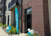 Thumbnail 16 of 18 - a brick building with balloons in front of it