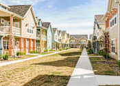 Thumbnail 2 of 37 - A row of houses with a sidewalk in front.