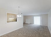 Thumbnail 28 of 47 - A room with a carpeted floor and a window with blinds.