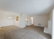 Thumbnail 36 of 47 - A spacious room with carpeted floor and white walls.