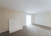 Thumbnail 41 of 47 - A room with a fireplace and carpeted floor.