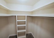 Thumbnail 26 of 47 - A white ladder in a white closet.