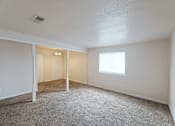Thumbnail 29 of 47 - A room with a carpeted floor and a window.