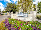 Thumbnail 1 of 47 - The entrance to Highland Hills is marked by a sign and a flower bed.