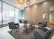 Thumbnail 9 of 47 - a lounge area with chairs and a table