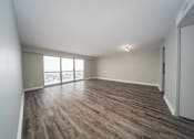 Thumbnail 32 of 47 - an empty living room with wood flooring and a window