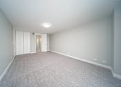 Thumbnail 37 of 47 - an empty living room with white walls and carpet