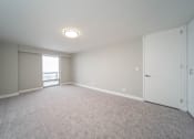 Thumbnail 39 of 47 - an empty living room with white walls and a window