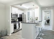 Thumbnail 9 of 17 - an open kitchen and dining area with a large counter top