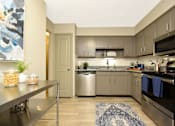 Thumbnail 8 of 18 - a kitchen with stainless steel appliances and granite counter tops