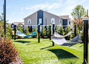 Thumbnail 4 of 17 - a yard with hammocks and houses in the background