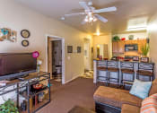 Thumbnail 11 of 16 - Furnished living area and breakfast bar with chairs