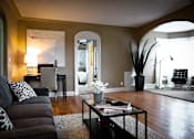 Thumbnail 28 of 66 - Living room with arched ceiling design and wood floors.