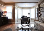 Thumbnail 27 of 66 - Furnished living room with wood floors and reading nook.