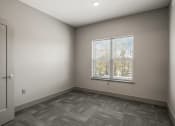 Thumbnail 12 of 18 - an empty room with a window and a door