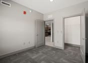 Thumbnail 13 of 18 - a bedroom with a door to a hallway and a closet