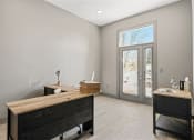 Thumbnail 9 of 18 - a bedroom with a desk and a door to a patio