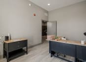 Thumbnail 8 of 18 - a office with a desk and a door to a hallway