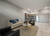 Thumbnail 4 of 18 - a living room with a couch and a table
