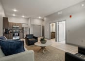 Thumbnail 5 of 18 - a living room with a couch and a table