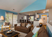 Thumbnail 1 of 26 - A living room with a brown couch and a coffee table.