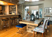 Thumbnail 21 of 26 - A dining area with a wooden table and chairs.