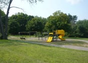 Thumbnail 15 of 17 - Playscape area in a park with trail and trees