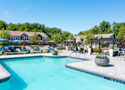 Thumbnail 3 of 17 - a resort pool with slides and buildings in the background