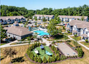 Thumbnail 6 of 17 - an aerial view of a community with houses and a swimming pool