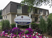 Thumbnail 13 of 17 - Shoreview Apartments Exterior monument sign with purple flowers