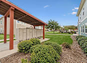 Thumbnail 22 of 37 - A building with a red roof and a covered walkway.