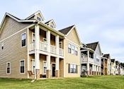 Thumbnail 3 of 37 - A row of townhouses with balconies and front porches.
