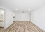 Thumbnail 11 of 14 - A room with wooden flooring and white walls.