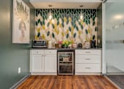 Thumbnail 8 of 25 - A kitchen with a green wall and a white cabinet.