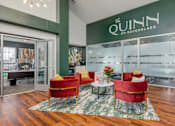 Thumbnail 3 of 25 - A room with a glass wall and a sign that says "The Quinn on Raven Glass".